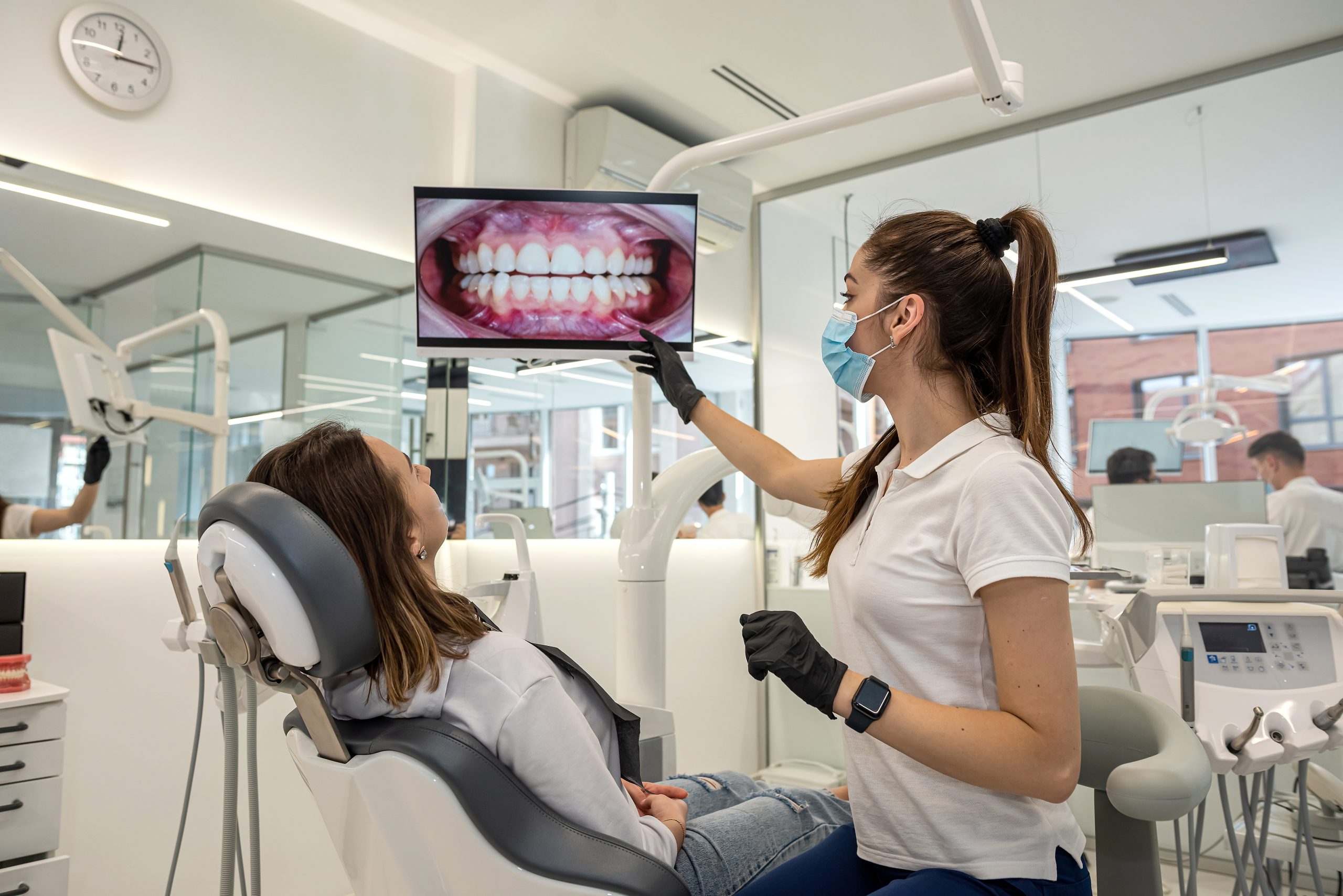 Dentist examining a young patient's mouth during an oral cancer screening